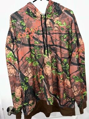 Brand new men’s size X-Large chucky  Camo Graphic Hoodie with Green Leaf Accents